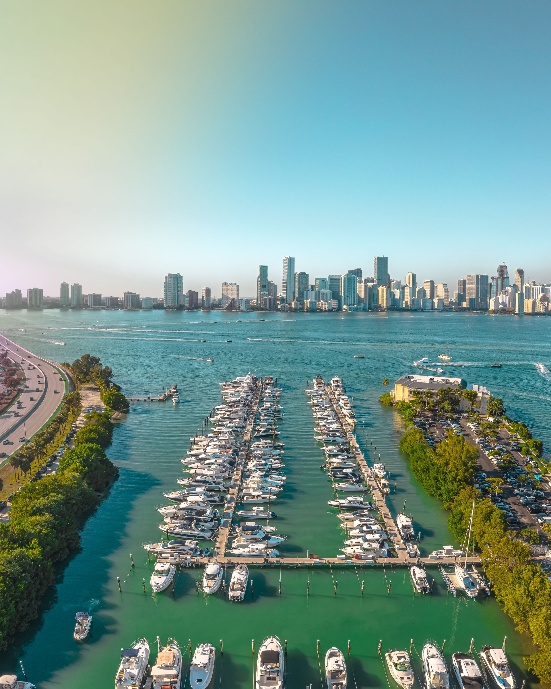 Drone View Of Yachts Lined Up In Front Of Miami Florida Skyline On A Beautiful Sunny Day